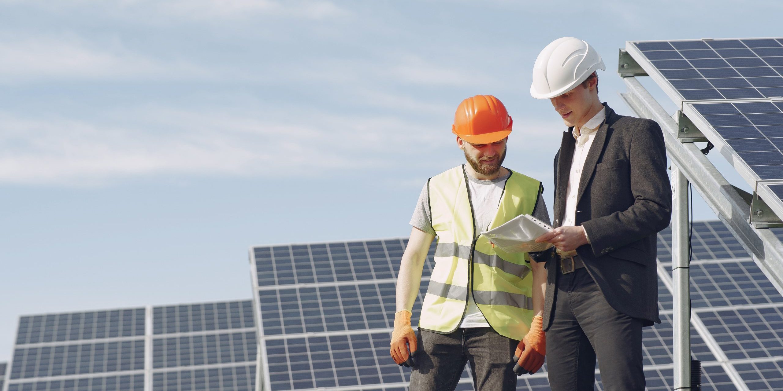 Foreman and businessman at solar energy station.